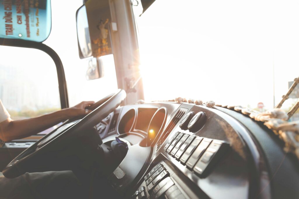 Skilled truck driver behind the wheel of a dump truck on a clear road."