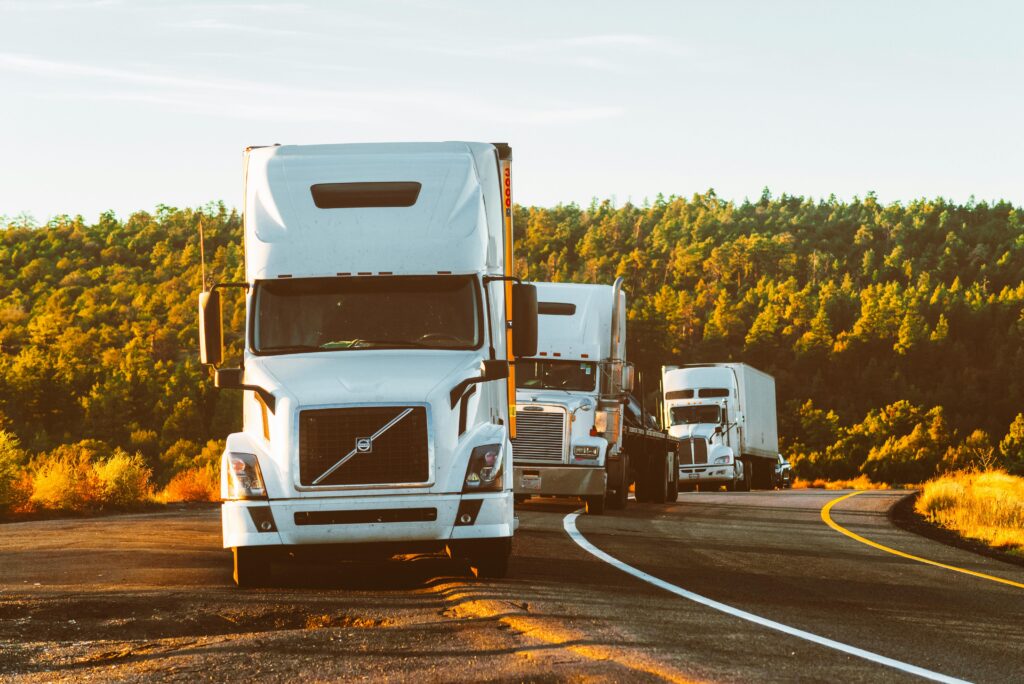 Professional truck driver performing a pre-trip inspection on a large commercial vehicle.
